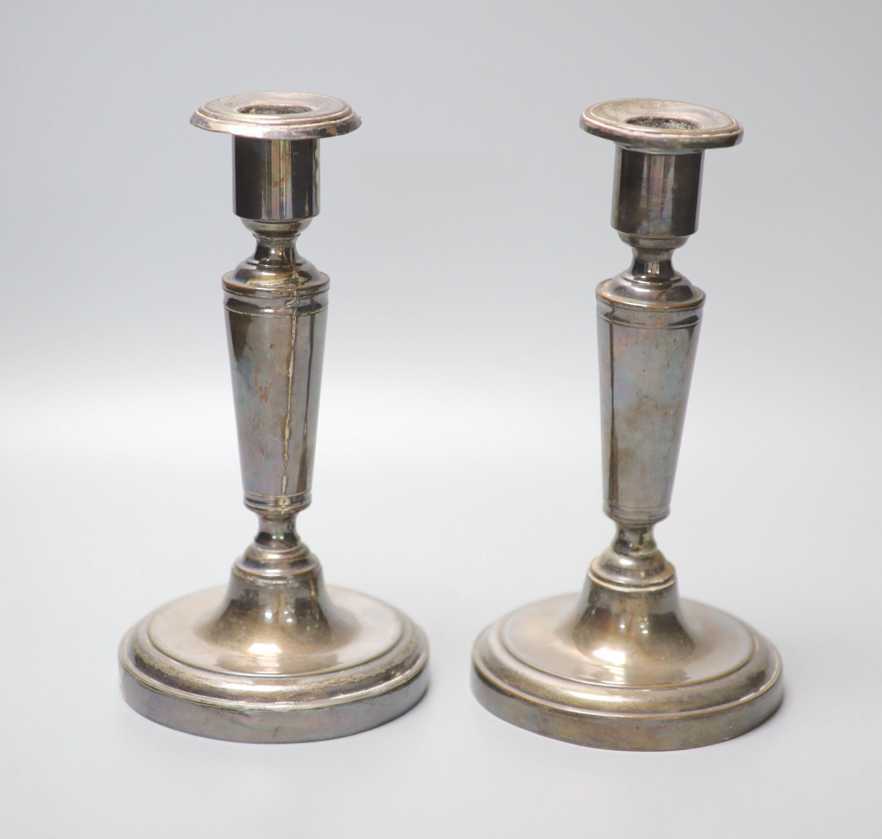 A pair of Austrian or Polish white metal candlesticks, height 20.8cm, gross 19.5oz.